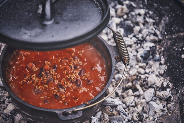 Cooking Chili Con Carne in Dutch Oven over Logfire Outside